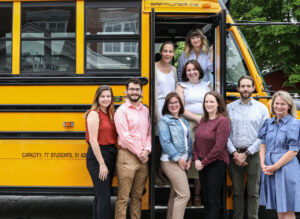 Staff from NHSFFP and Reaching Higher NH in the door of a school bus